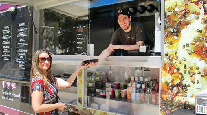 A customer who didn’t want to be identified buying food from The Healthy Scratch at Niagara Square in Buffalo in mid June.