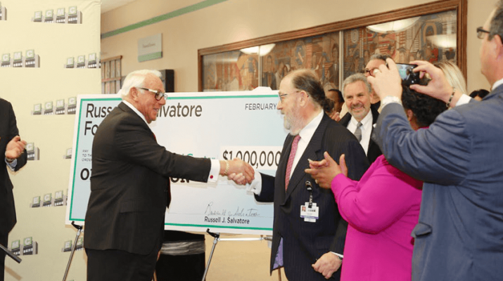 Russ Salvatore is thanked by Jonathan A. Dandes, right, chairman of the ECMC board of directors after he donated $1 million to the hospital.