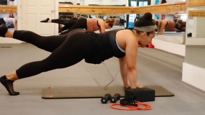 Rachael Humphrey-Leonard leads a barre class at Barre Centric’s East Aurora location.