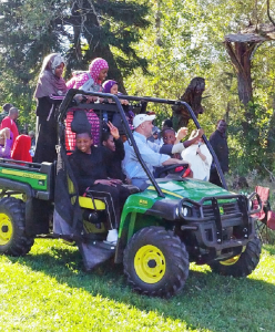 Physician Christopher Kerr, CEO of the Center for Hospice and Palliative Care, takes some refugees to tour his East Aurora farm.
