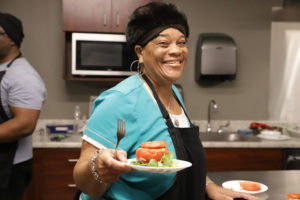 GBUAHN member Terry Daniels-Brown presents her stuffed tomato dish, made during one of GBUAHN’s Member Cooking Classes.