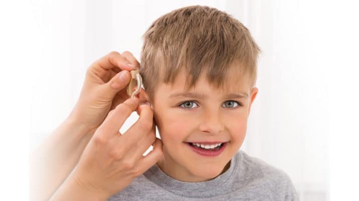 Boy with hearing aid