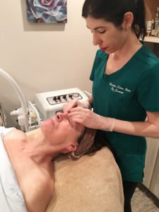 Janine Testa, owner of Holistic Skin Care by Janine in Williamsville, applying a charcoal mask on a client’s face. “It’s good for people who have clogged pores, blackheads and oily skin. It’s good for acne. But they can be drying.”