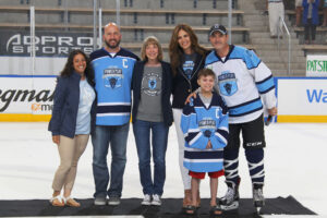 Amy and Mike Lesakowski, back right, with Roswell Park Comprehensive Cancer Center President and CEO Candace S. Johnson and beneficiaries of the funds the event raises for cancer research and treatment. Photo by Bill Wippert, courtesy of 11 Day Power Play.