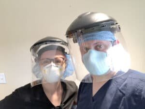 Jenni Attea and Seth Wagner, family nurse practitioners, working in one of Jericho Road Community Health Center’s COVID isolation units.